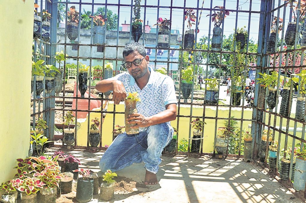 This railway department employee makes best use of discarded plastic drinking water bottles