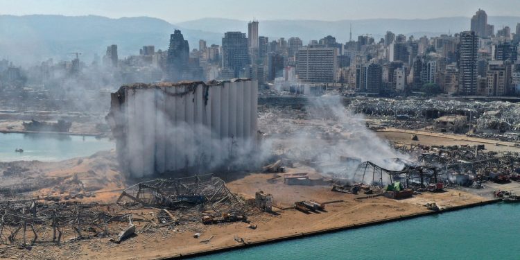 An aerial view shows the massive damage done to Beirut Port's grain silos (centre) and the area around it August 5, 2020, a day after a mega-blast tore through the harbor in the heart of the Lebanese capital. (Photo courtesy: AFP via asiatimes.com)