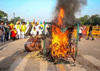 Punjab Youth Congress activists set on fire a tractor near India Gate during a protest against the new farm laws, in New Delhi. (PTI Photo)