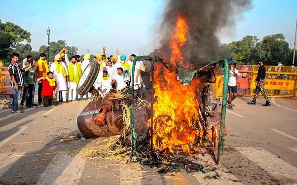 Punjab Youth Congress activists set on fire a tractor near India Gate during a protest against the new farm laws, in New Delhi. (PTI Photo)