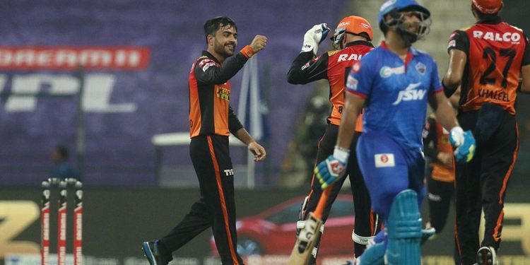 Rashid Khan (L) celebrates with teammates after dismissing a DC batsman, Tuesday