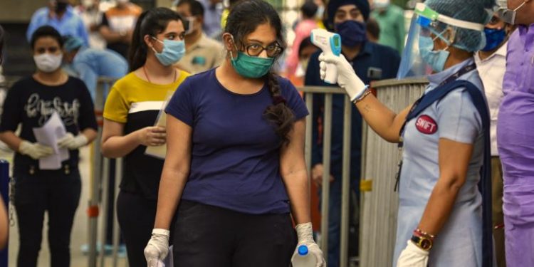 New Delhi: Aspirants undergo thermal screening as they enter an examination centre for appearing in the National Eligibility cum Entrance Test (NEET) in New Delhi, Sunday, Sept. 13, 2020. (PTI Photo/Ravi Choudhary)