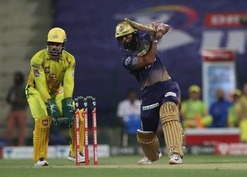 Rahul Tripathi drives through the offside during his innings as MS Dhoni looks on, Wednesday