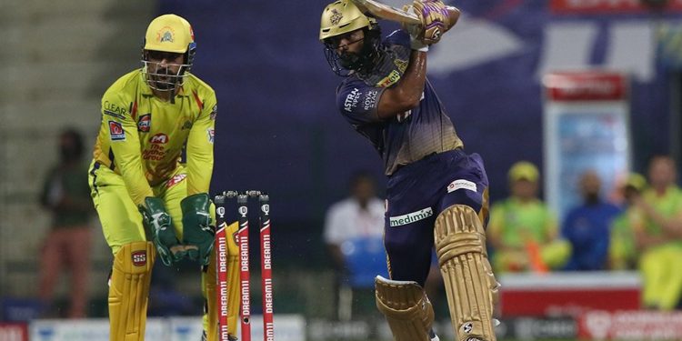 Rahul Tripathi drives through the offside during his innings as MS Dhoni looks on, Wednesday