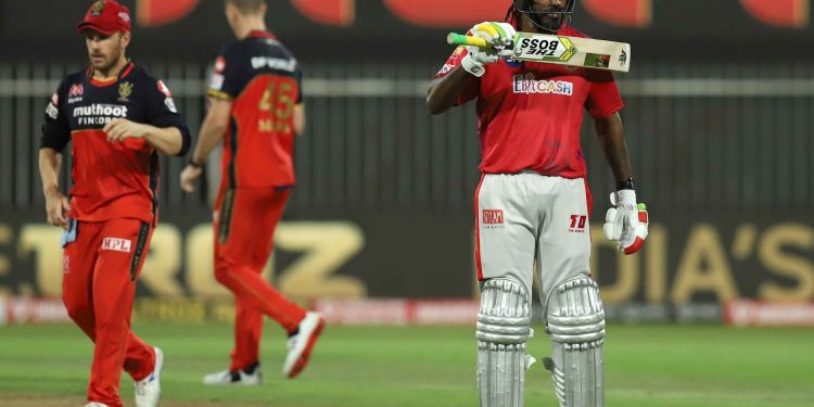 Chris Gayle shows off 'The Boss' sticker on his bat after reaching 50 against RCB in Sharjah, Thursday
