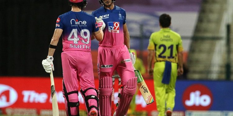 Jos Buttler (R) and Steve Smith congratulate each other after completing 50 runs of partnership against CSK in Abu Dhabi, Monday