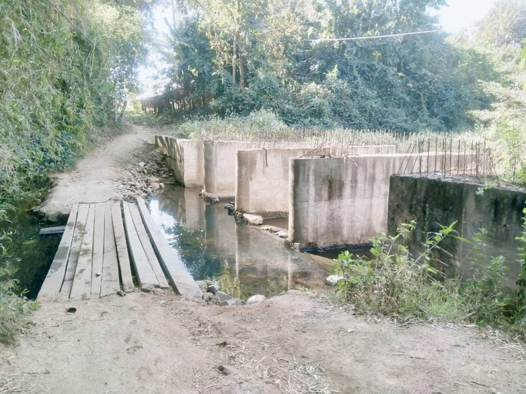 Four years on, bridge remains half-constructed; villagers warn of protests
