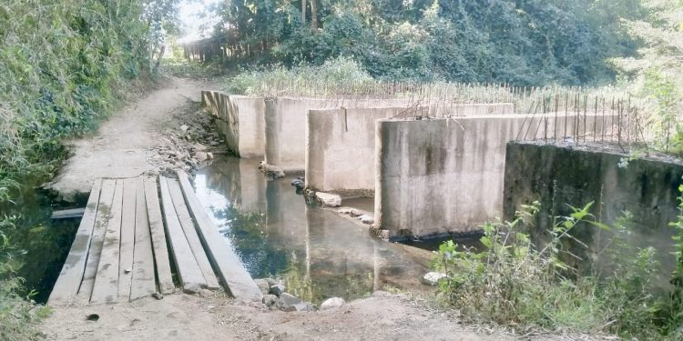 Four years on, bridge remains half-constructed; villagers warn of protests