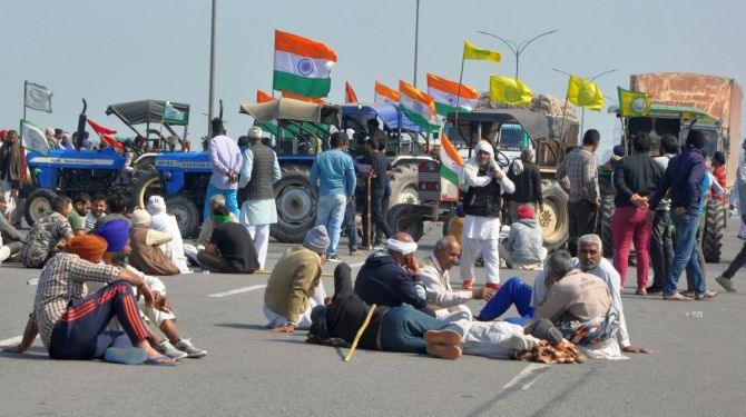 File photo of farmers blocking a road at Singhu border during their ‘chakka jam’ protest as part of the agitation over new farm laws near New Delhi. (PC: PTI Photo)