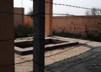 Barbed wire  divides cremation ground.