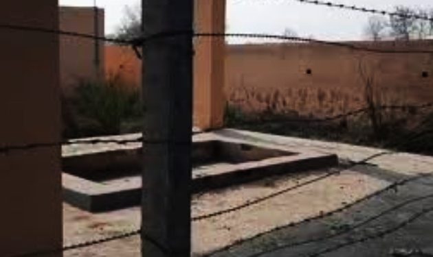 Barbed wire  divides cremation ground.