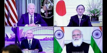 A monitor displaying a virtual meeting with U.S. President Joe Biden (top L), Australia's Prime Minister Scott Morrison (bottom L), Japan's Prime Minister Yoshihide Suga (top R) and India's Prime Minister Narendra Modi is seen during the virtual Quadrilateral Security Dialogue (Quad) meeting, at Suga's official residence in Tokyo March 12, 2021. (PC: onmanorama.com)