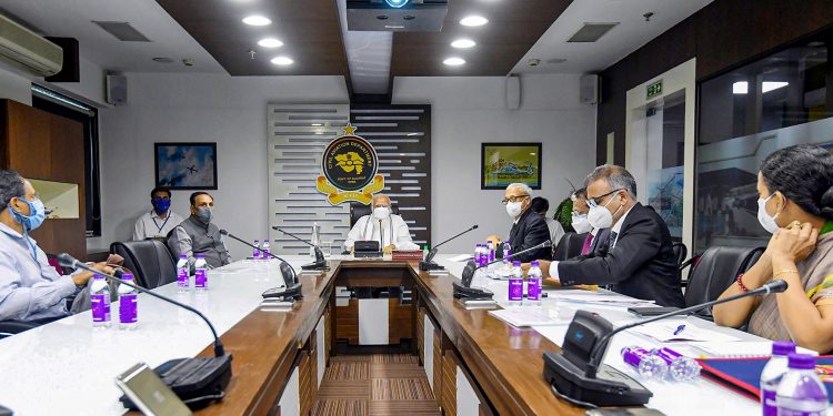 Prime Minister Narendra Modi with Gujarat CM Vijay Rupani (L) holds a review meeting with the officials to assess the damage caused by Cyclone Tauktae, in Ahmedabad, May 19, 2021. (PIB/PTI Photo)