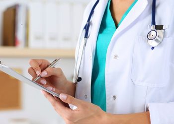 Female medicine doctor hand holding silver pen