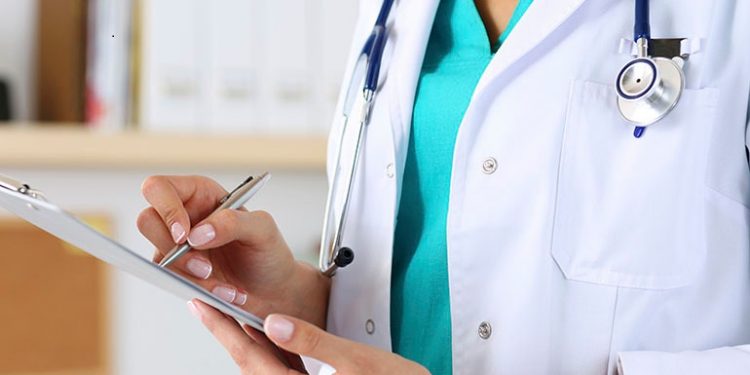 Female medicine doctor hand holding silver pen