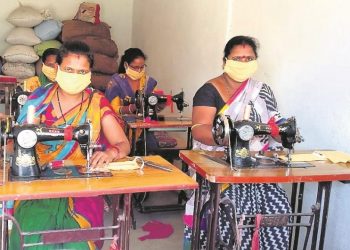 File photo of members of a self-help group stitching face masks