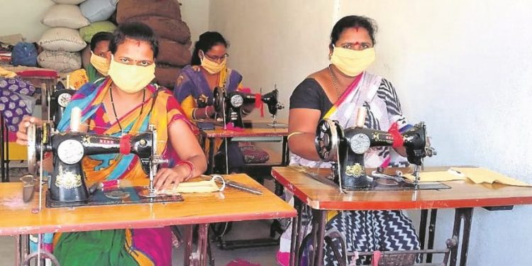 File photo of members of a self-help group stitching face masks