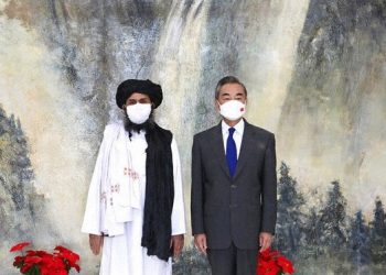 In this July 28, 2021 file photo released by China's Xinhua News Agency, Taliban co-founder Mullah Abdul Ghani Baradar, left, and Chinese Foreign Minister Wang Yi pose for a photo during their meeting in Tianjin, China. (Li Ran/Xinhua via AP, File)