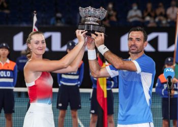 France's Kristina Mladenovic and Croatia's Ivan Dodig pose with the trophy after the mixed doubles final against Australia's Jaimee Fourlis and Jason Kubler on day twelve of the Australian Open tennis tournament in Melbourne on January 28, 2022. (Photo by BRANDON MALONE / AFP) / -- IMAGE RESTRICTED TO EDITORIAL USE - STRICTLY NO COMMERCIAL USE --