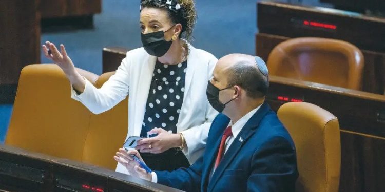 Prime Minister Naftali Bennett and MK Idit Silman seen in better days for them at a Knesset plenum session last July. (Photo credit: OLIVIER FITOUSSI/FLASH90 via jpost.com)