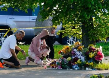 People pay their respects outside the scene of a shooting at a supermarket in Buffalo, New York. (Photograph: Matt Rourke/AP via theguardian.com)