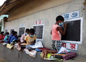 Children, who do not have access to internet facilities and gadgets, attend an open-air class outside the houses with the walls converted into black boards following the closure of their schools due to the coronavirus disease outbreak, at Joba Attpara village in Paschim Bardhaman district, West Bengal. (PC: Reuters/Rupak De Chowdhuri)