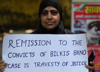 An activist holds a placard during a protest against the reease of the 11 convicts in the Bilkis Bano case. Credit AFP Photo