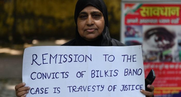 An activist holds a placard during a protest against the reease of the 11 convicts in the Bilkis Bano case. Credit AFP Photo