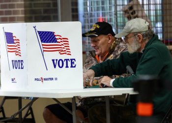 Voters fill out ballots at a polling station during the 2022 U.S. midterm election in downtown Harrisburg, Pennsylvania, U.S., November 8, 2022. REUTERS/Mike Segar