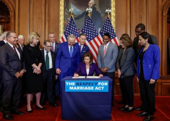 U.S. House Speaker Nancy Pelosi (D-CA) signs "The Respect for Marriage Act" alongside fellow members of Congress, during a bill enrollment ceremony on Capitol Hill, in Washington, U.S., December 8, 2022. REUTERS/Evelyn Hockstein