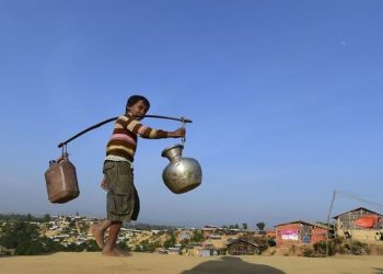 A Rohingya refugee child walks back to his makeshift shelter after collecting water at Hakimpara refugee camp in Bangladesh’s Ukhia district January 27, 2018. (AFP)