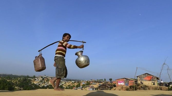 A Rohingya refugee child walks back to his makeshift shelter after collecting water at Hakimpara refugee camp in Bangladesh’s Ukhia district January 27, 2018. (AFP)