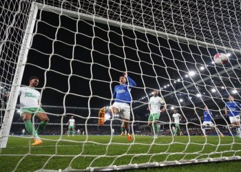 Newcastle's Jacob Murphy, left, scores his side's fourth goal during the English Premier League soccer match between Everton and Newcastle United at the Goodison Park stadium in Liverpool, England, Thursday, April 27, 2023. (AP Photo/Jon Super)