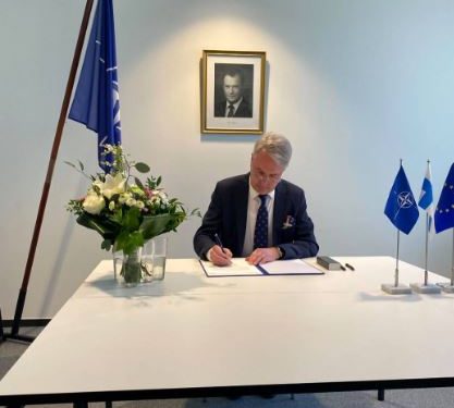 Finnish Foreign Minister Pekka Haavisto signing Finland’s instrument of accession to NATO (Image: P_Kallioniemi/Twitter)