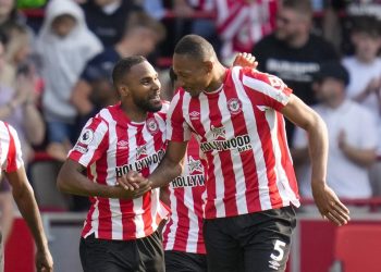 Brentford's Ethan Pinnock, right, celebrates with Brentford's Rico Henry after scoring his side's opening goal during the English Premier League soccer match between Brentford and Manchester City at the Gtech Community Stadium in London, Sunday, May 28, 2023. (AP Photo/Kirsty Wigglesworth)