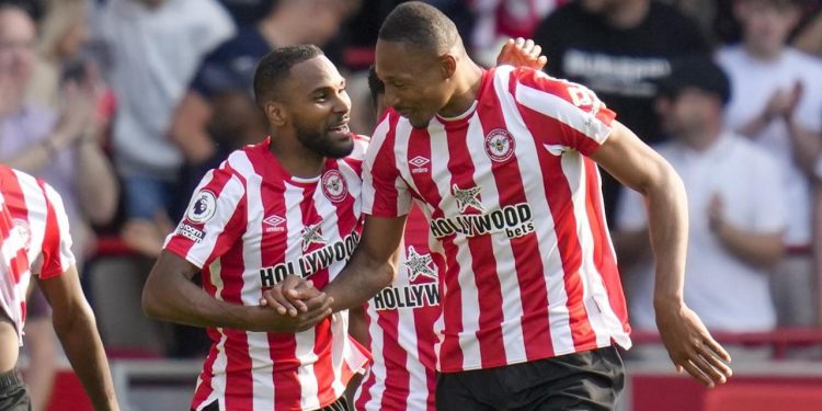 Brentford's Ethan Pinnock, right, celebrates with Brentford's Rico Henry after scoring his side's opening goal during the English Premier League soccer match between Brentford and Manchester City at the Gtech Community Stadium in London, Sunday, May 28, 2023. (AP Photo/Kirsty Wigglesworth)