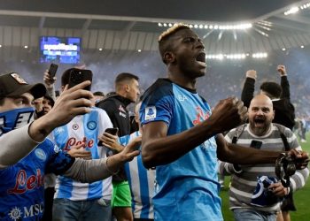 Napoli fans join Napoli's Nigerian forward Victor Osimhen (C) as he celebrates after the Italian Serie A football match between Udinese and Napoli on May 4, 2023 at the Friuli stadium in Udine.  Napoli ended a 33-year wait to win Italy's Serie A on May 4 after a 1-1 draw at Udinese secured their third league title and emulated the great teams led by Diego Maradona. (Photo by Andrea STACCIOLI / AFP)