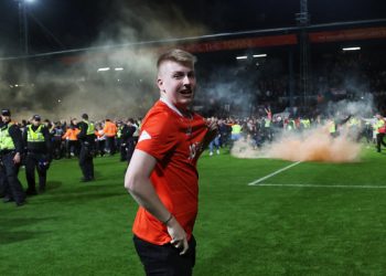 Soccer Football - Championship - Play-off - Semi Final - Second Leg - Luton Town v Sunderland - Kenilworth Road, Luton, Britain - May 16, 2023
A Luton Town fan celebrates during a pitch invasion after the match Action Images via Reuters/Lee Smith EDITORIAL USE ONLY. No use with unauthorized audio, video, data, fixture lists, club/league logos or 'live' services. Online in-match use limited to 75 images, no video emulation. No use in betting, games or single club	/league/player publications.  Please contact your account representative for further details.