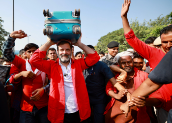 Rahul Gandhi interacts with porters at Anand Vihar railway station