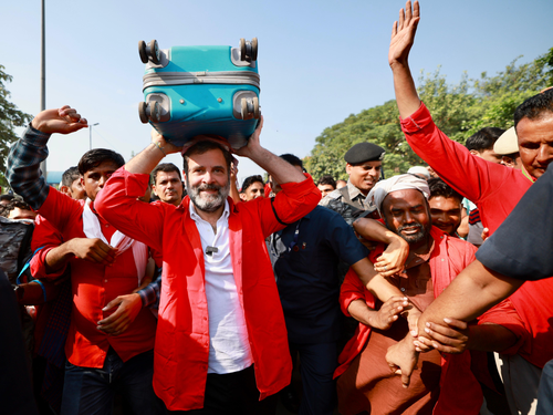 Rahul Gandhi interacts with porters at Anand Vihar railway station