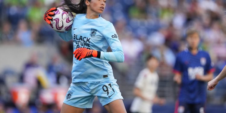FILE - OL Reign goalkeeper Phallon Tullis-Joyce handles the ball against the Portland Thorns during the first half of an NWSL soccer match, June 3, 2023, in Seattle. Manchester United signed Tullis-Joyce on Thursday, Sept. 14, on a permanent deal from the Reign. Tullis-Joyce previously played in Europe with French club Reims. United did not specify the length of the contract or value of her transfer. (AP Photo/Lindsey Wasson, File)