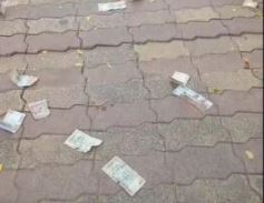 Customers throw currency notes in front of RBI office in Bhubaneswar