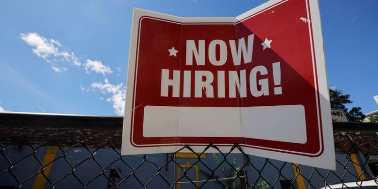 FILE PHOTO: A "now hiring" sign is displayed outside Taylor Party and Equipment Rentals in Somerville, Massachusetts, U.S., September 1, 2022. REUTERS/Brian Snyder
