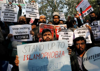 Demonstrators hold placards during a protest against what they say is hate speech against Muslims by Hindu leaders, in New Delhi, India, December 27, 2021. REUTERS/Adnan Abidi