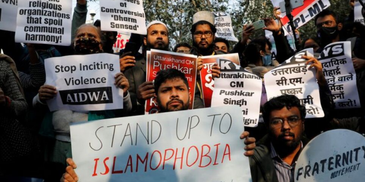 Demonstrators hold placards during a protest against what they say is hate speech against Muslims by Hindu leaders, in New Delhi, India, December 27, 2021. REUTERS/Adnan Abidi