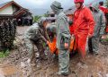 Rescuers carry the body of a flood victim in Malalak, West Sumatra, Indonesia, Friday, Nov. 28, 2025. (AP Photo/Ade Yuandha)