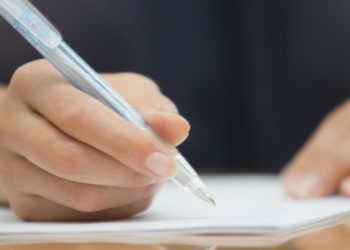 Woman writing with pen