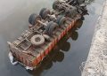Rice-laden truck plunges into river
